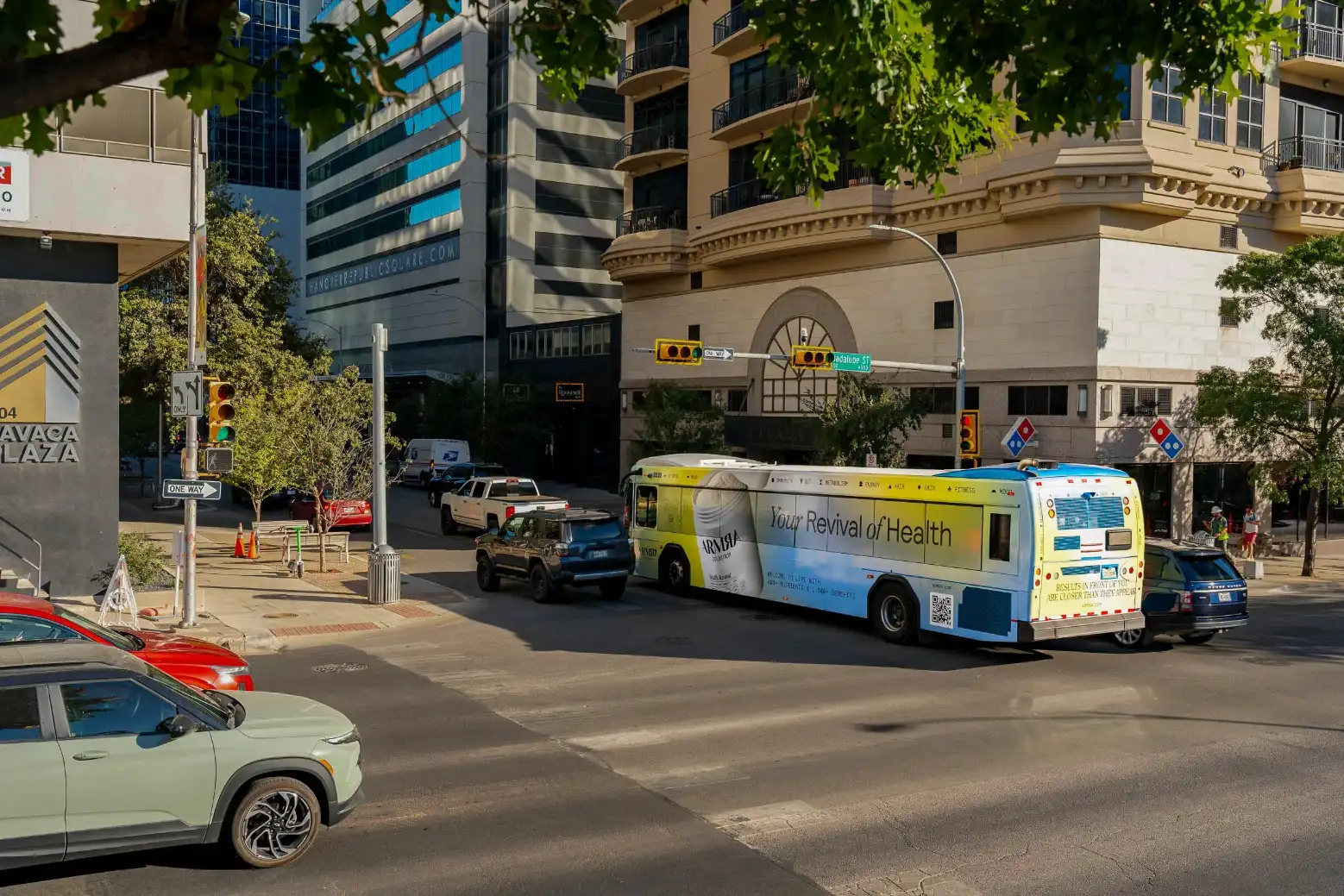 City bus with a full ARMRA wrap on an Austin street