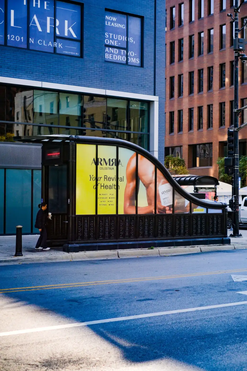 ARMRA ad on a curved bus shelter on a Chicago street