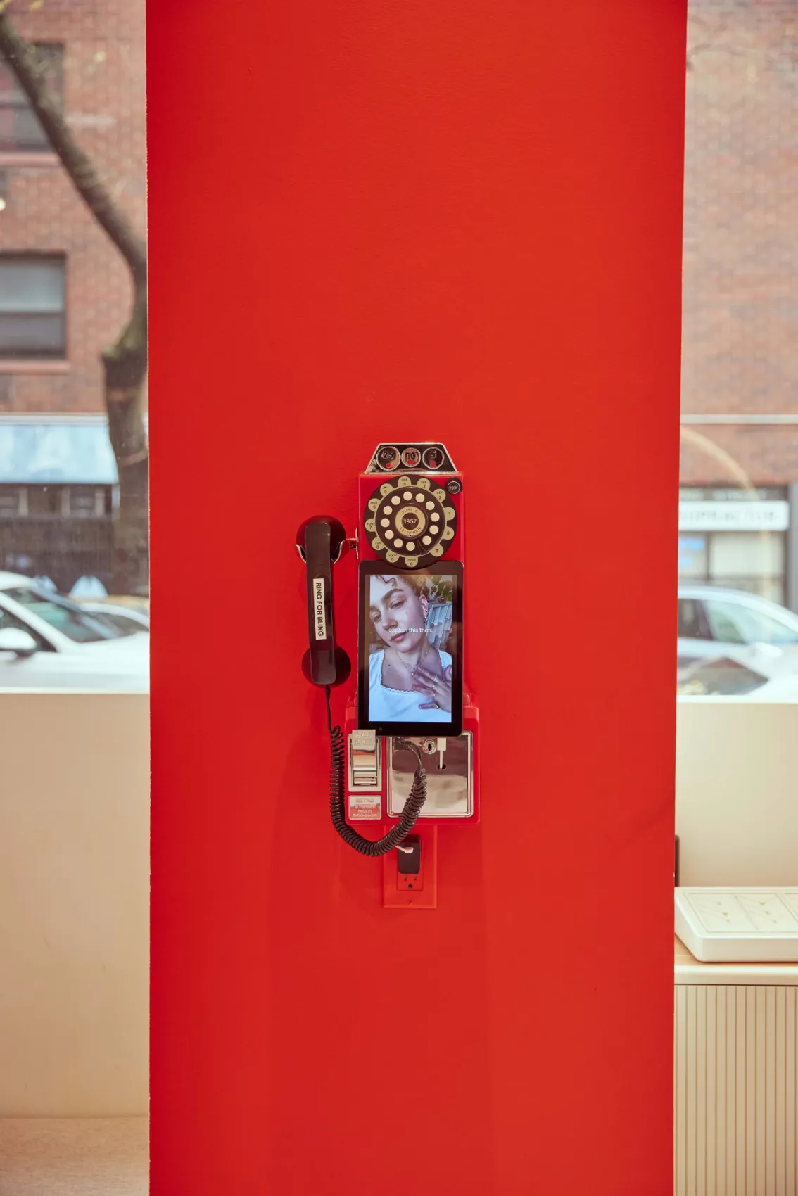 Red column fitted with a vintage payphone