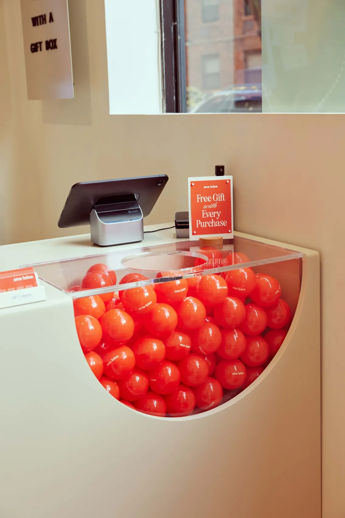 Checkout counter with a ball pit of red balls for free gifts