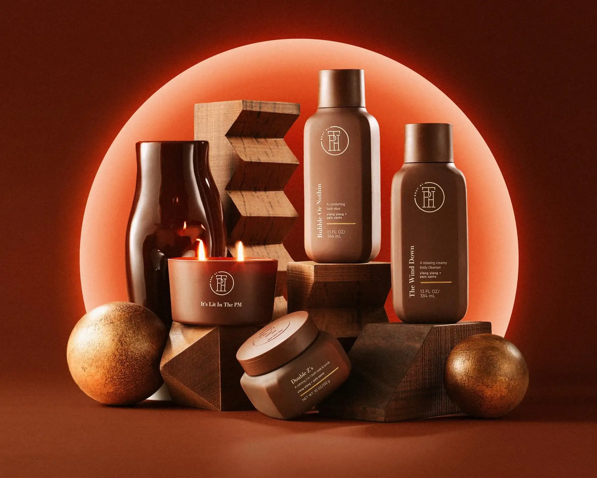 TPH Body products arranged on wooden shapes in front of an orange halo