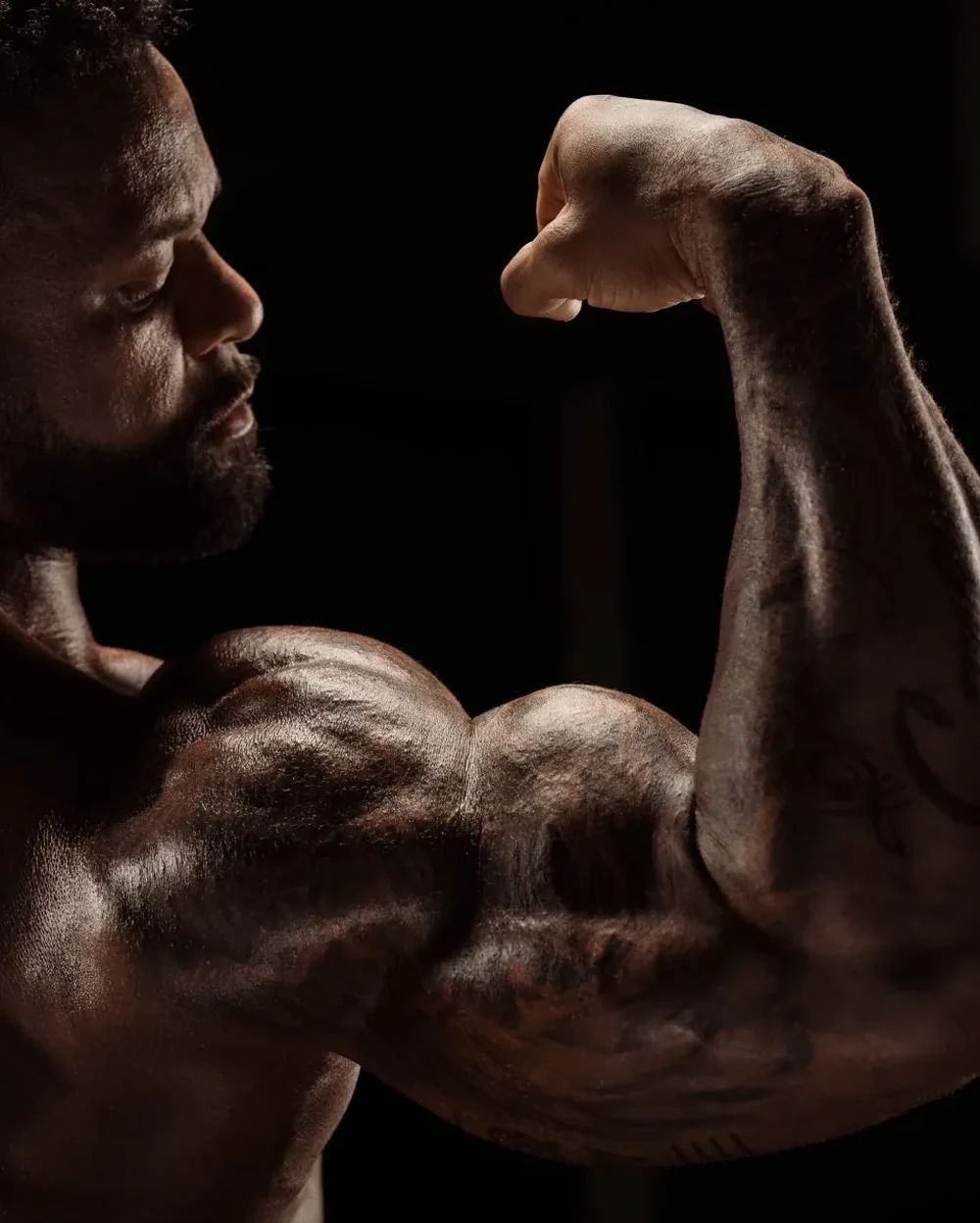 Arms target: Shaun T flexing his biceps