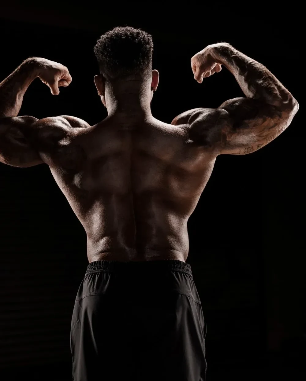 Back target: Shaun T in a back double-biceps pose